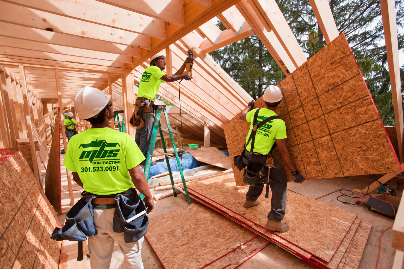 Illustrative framing crew wearing safety-green MBS Contracting shirts with the company phone number
